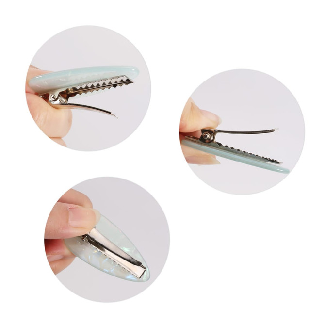 A teardrop-shaped iridescent alligator hair clip in light blue, shown from multiple angles, with a silver clip mechanism.