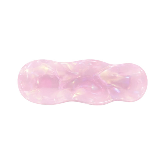 A pink iridescent alligator hair clip with a wavy design and a glossy finish. Contains branding.