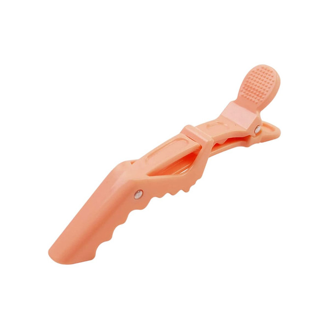 An anti-slip alligator clip in a soft peach colour, featuring a textured grip and a branding logo.