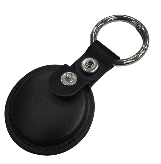 A black tracking tag with a keyring attached, featuring a leather case and metal snap.