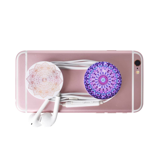 A pink phone with two decorative pop holders and white earphones bundled together.