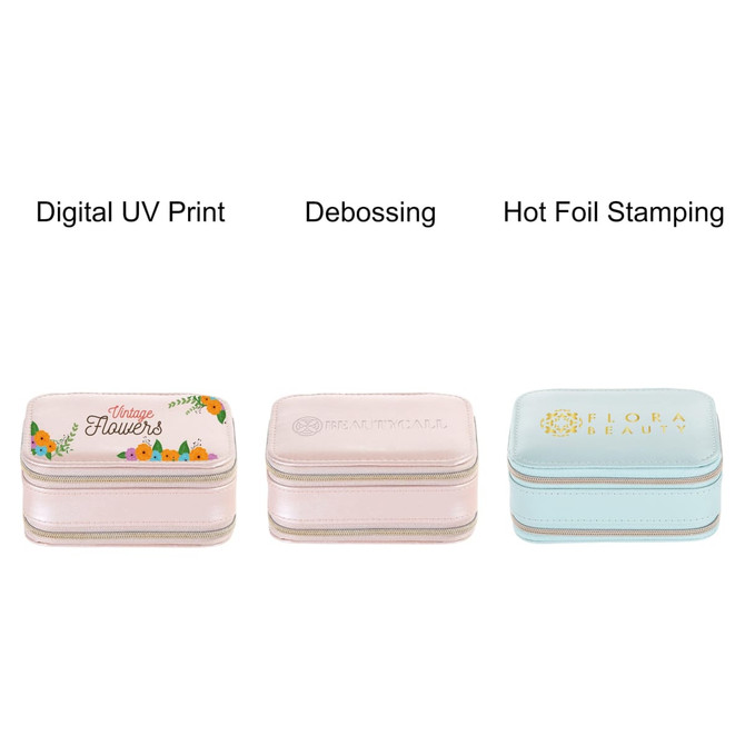 A collection of three jewellery cases in various pastel colours, featuring different decorative designs and finishes.