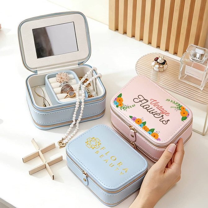 A pink and blue fashion PU leather jewellery case with a mirror, featuring decorative floral designs and interior compartments.