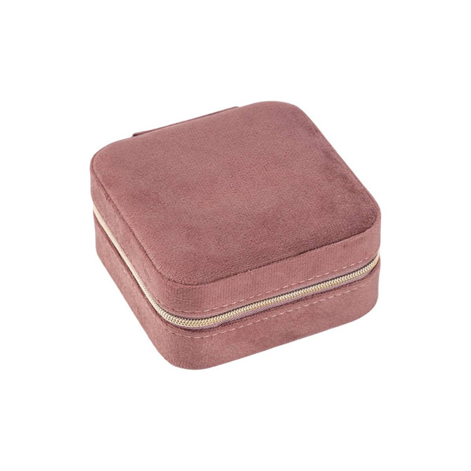 A square, soft, pink velvet jewellery organiser with a zip closure. It has a smooth, textured surface.