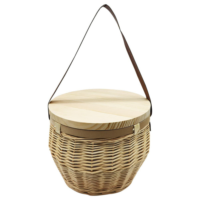 A natural woven basket with a round wooden lid and a brown shoulder strap. It features a textured finish.