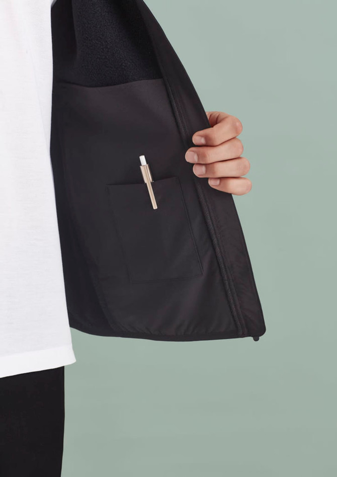 A black vest featuring an inner pocket with a pen holder, showcased against a muted background.