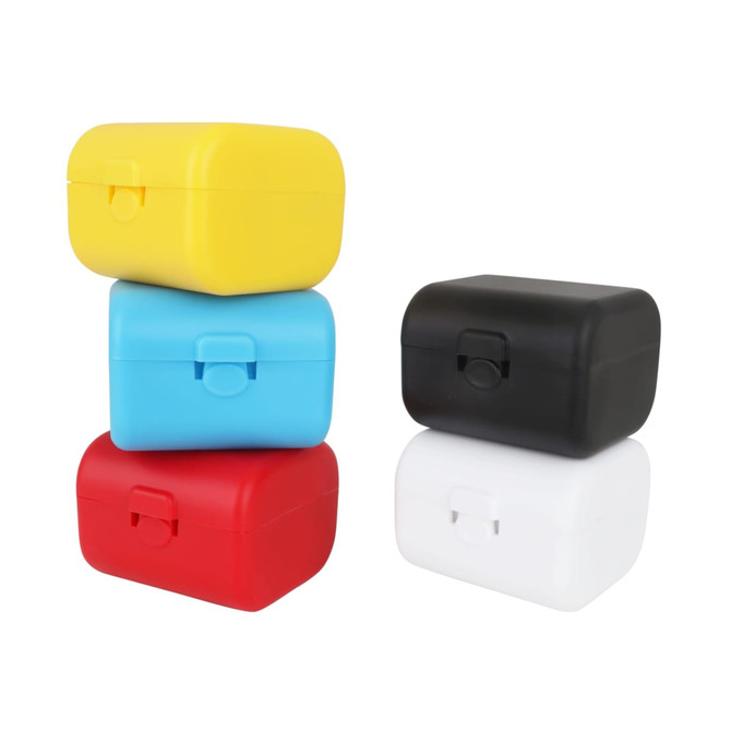 A stack of four travel adapter kits in yellow, blue, red, and black. Each kit features a clasp closure.