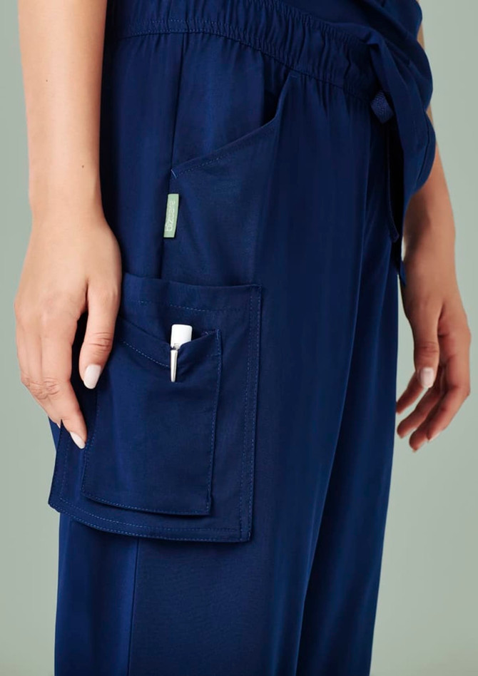 Navy blue women's straight leg scrub pants with a side pocket, featuring a logo.
