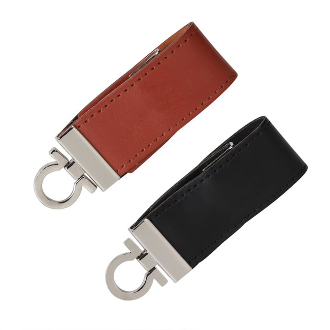 A sleek leather flash drive in brown and black, featuring a metal clasp and an attached ring for easy carrying.