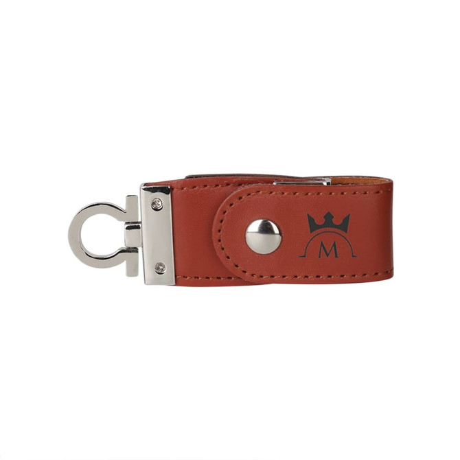 A brown leather flash drive with a silver clasp and an embossed logo on the side.