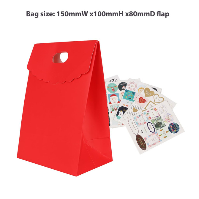 A red die cut handle bag with a flap, alongside assorted decorative stickers. The bag features a logo.
