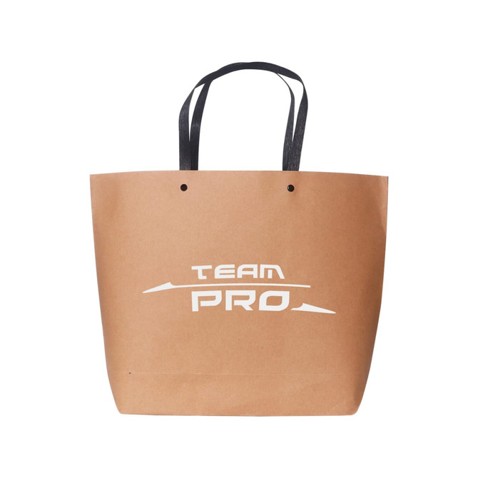 A medium brown paper bag with black handles and a logo on the front.