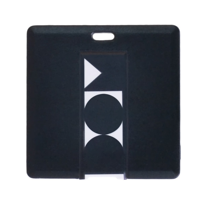 A square black flash drive featuring a geometric design and a small hole for easy attachment.