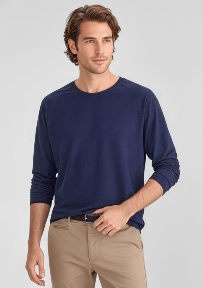 A navy long sleeve tee for men, featuring a relaxed fit and a logo. Paired with light-coloured pants.