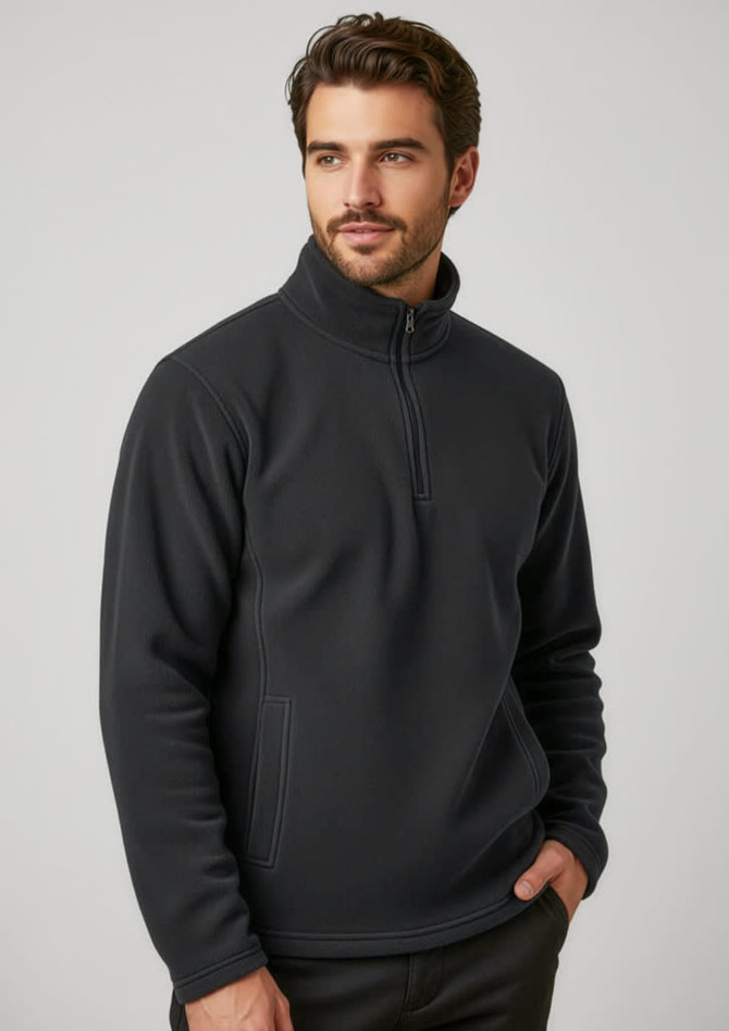 A black polar fleece jacket featuring a quarter-zip and a side pocket, worn by a man. Includes a logo.