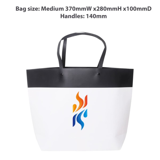 A medium black and white boutique paper bag with handles, featuring a logo design in vibrant colours.
