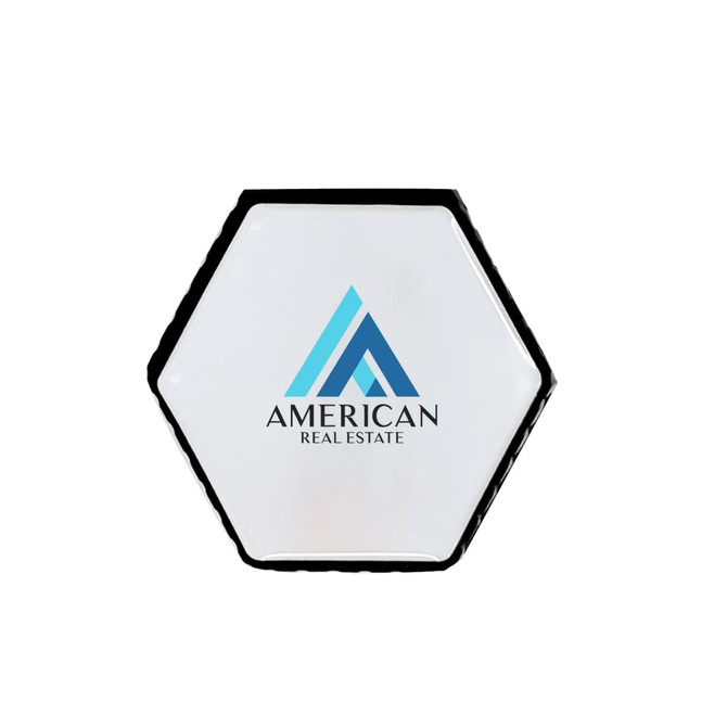 A hexagonal-shaped flash drive in white and black with a logo on the front.