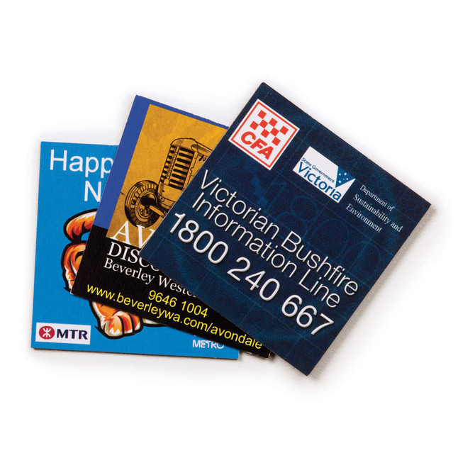 Three fridge magnets featuring colourful designs and logos, including a blue cartoonish character and text details.