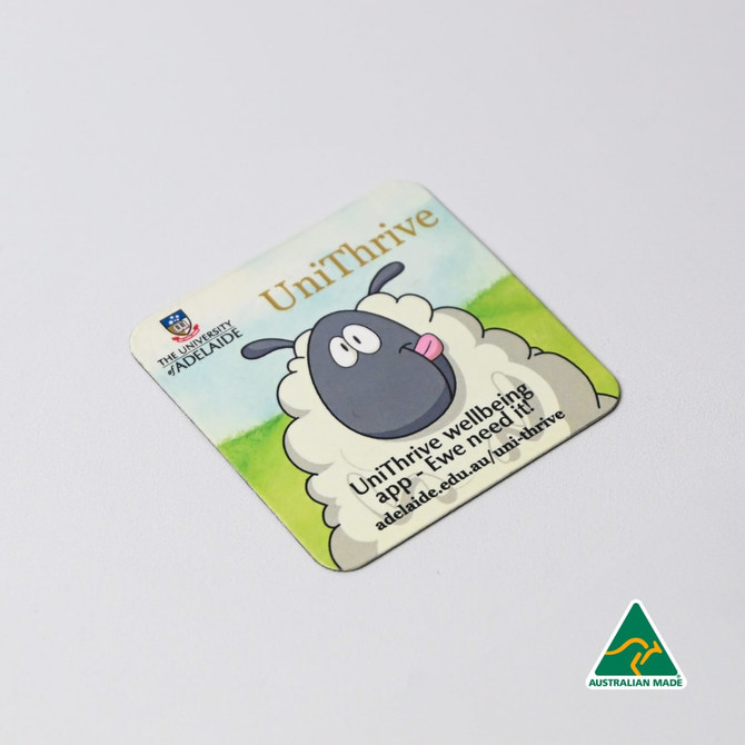 A square fridge magnet featuring a cartoon sheep and a logo, with a light background and rounded corners.