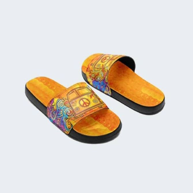 A pair of colourful sandals featuring a vibrant design with peace signs and a stylised van.
