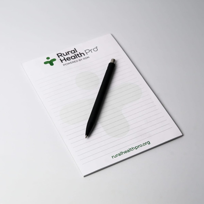 A5 notepad with 25 leaves, featuring a white background and a black pen, includes a logo at the top.