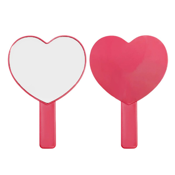 A heart-shaped handheld mirror with a pink handle, featuring a smooth reflective surface.