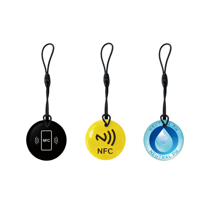 Three round NFC epoxy tags in black, yellow, and blue, each with a strap, featuring different designs.