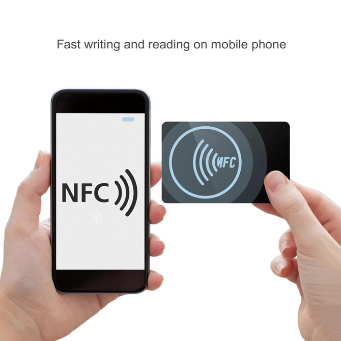 A hand holds a NFC PVC business card beside a smartphone displaying an NFC symbol. The card is black with a logo.