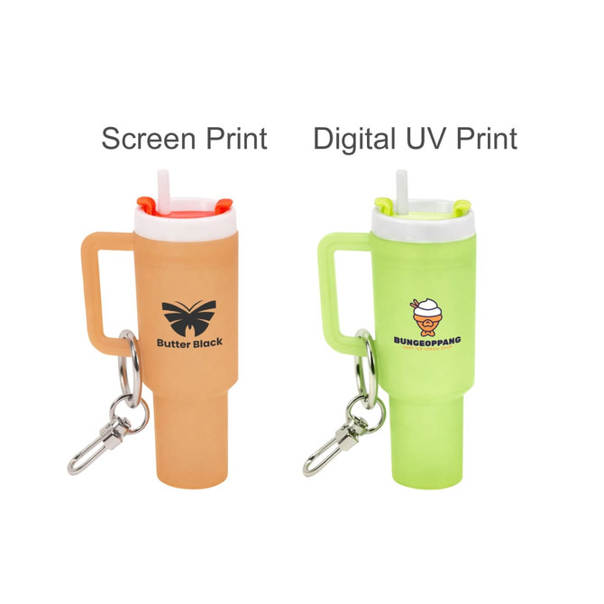 A glowing mini tumbler keyring in orange and green, featuring logos and an attached keyring clip.