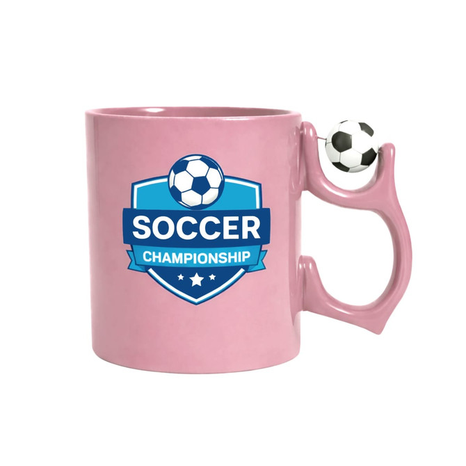 A pink ceramic mug with a soccer-themed logo and a soccer ball-shaped handle. It includes a branding logo.