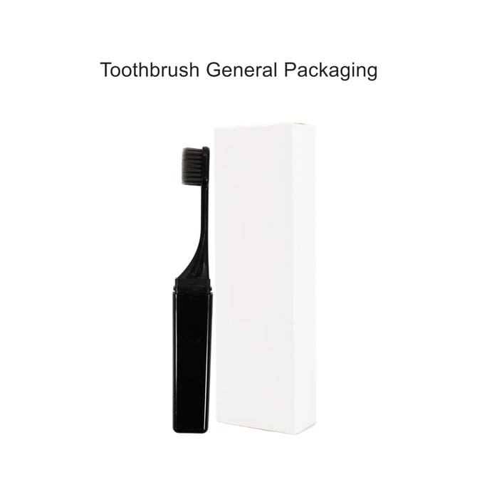 A black foldable travel toothbrush beside its white packaging. The packaging has a logo.