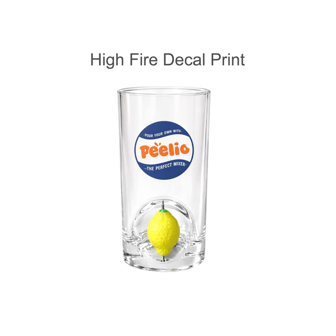 A glass cup with a custom spinner toy featuring a yellow lemon inside and a decorative logo.