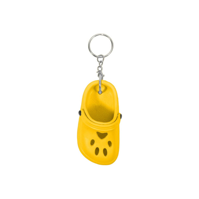A yellow paw-shaped clog shoe keyring with a metal ring attachment. It features ventilation holes and a rounded toe.
