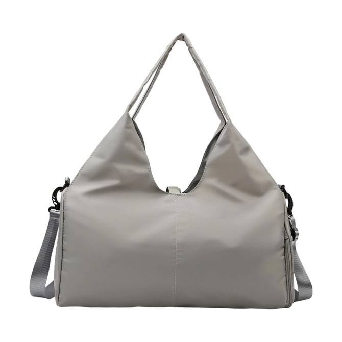 A grey duffle bag featuring a yoga mat strap and an adjustable shoulder strap, with a sleek design and logo present.
