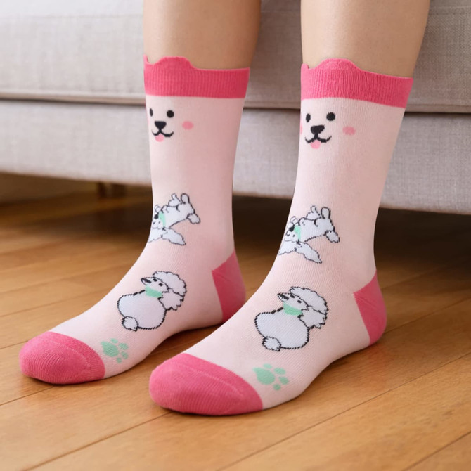 Ear-shaped crew socks with pink accents featuring a playful dog pattern on a light pink background.
