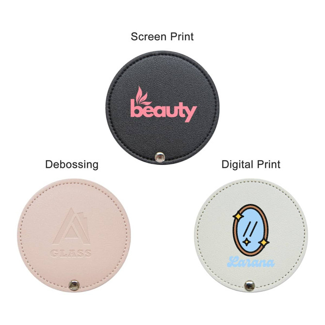 A round makeup mirror featuring three design options: black, pink, and cream with various prints and a logo.
