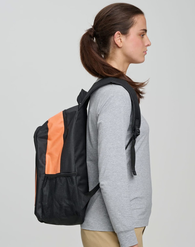 A black backpack with an orange stripe worn by a woman, featuring a logo on the front.