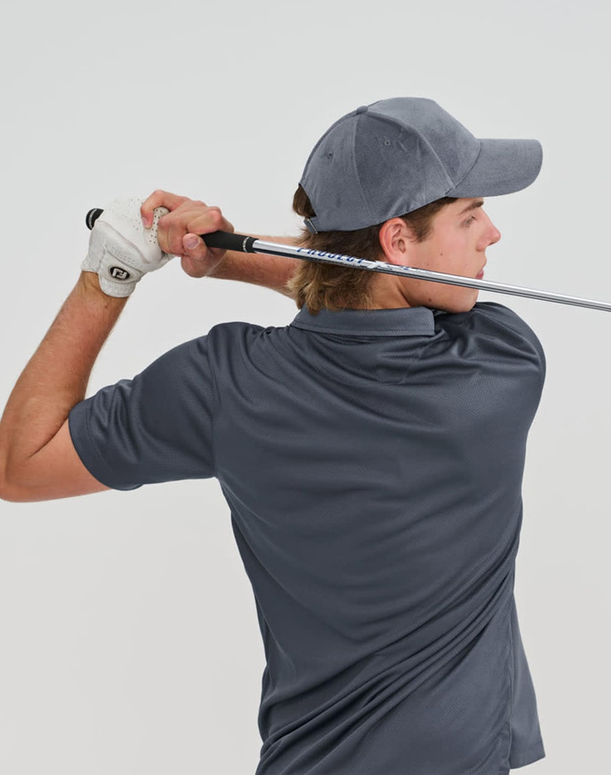 A grey Jacquard Texture 5 Panel Cap worn by a golfer, with a golf club in hand, viewed from behind.