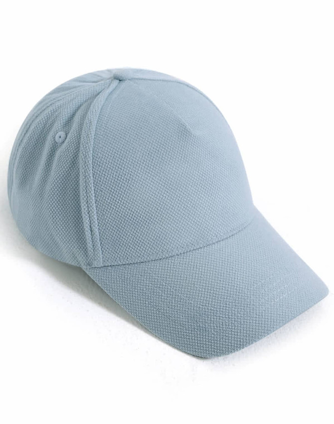 A light blue 5-panel cap with a jacquard texture featuring a logo on the side.