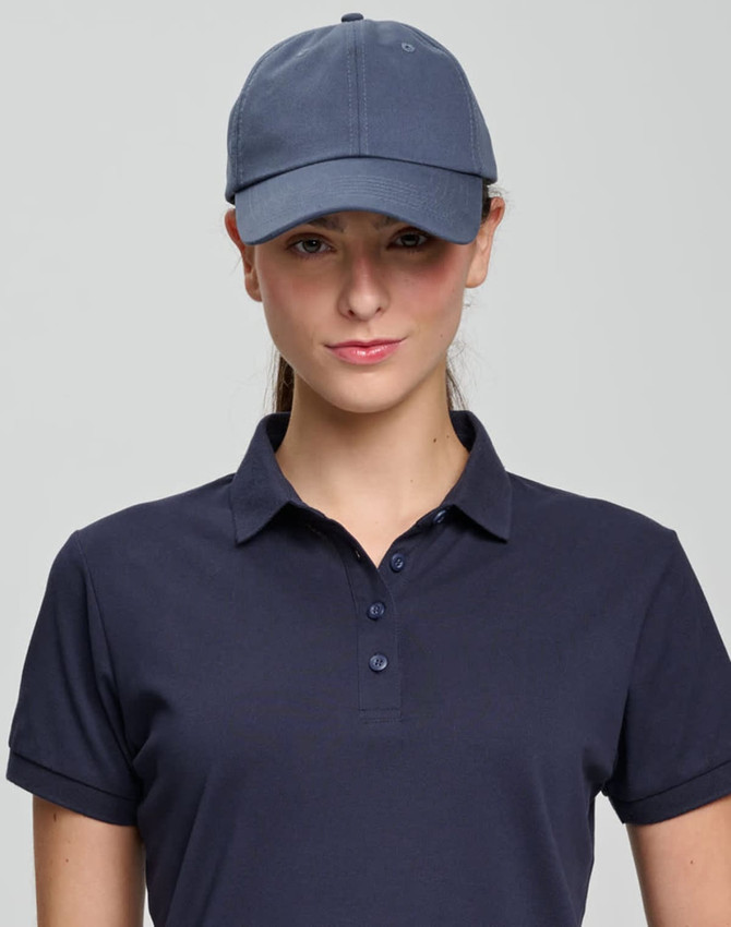 A navy cotton twill unstructured cap worn by a model, featuring a logo on the front.