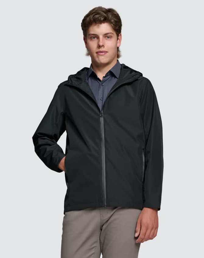 A unisex black waterproof jacket with a hood, worn by a model with light brown hair. Features a logo on the chest.
