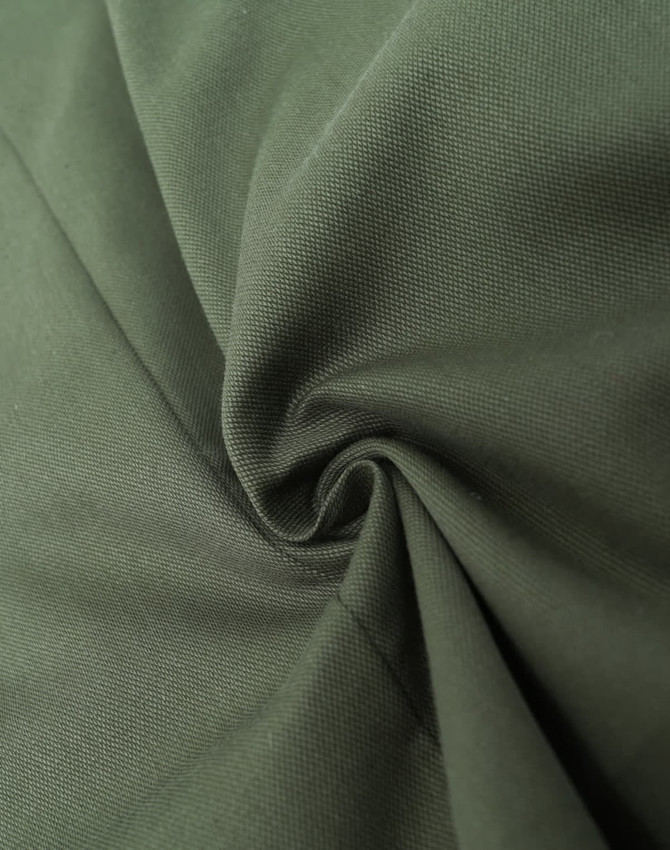 A cotton blend fabric in a rich olive green, showcasing a smooth, textured weave. Features branding in the corner.
