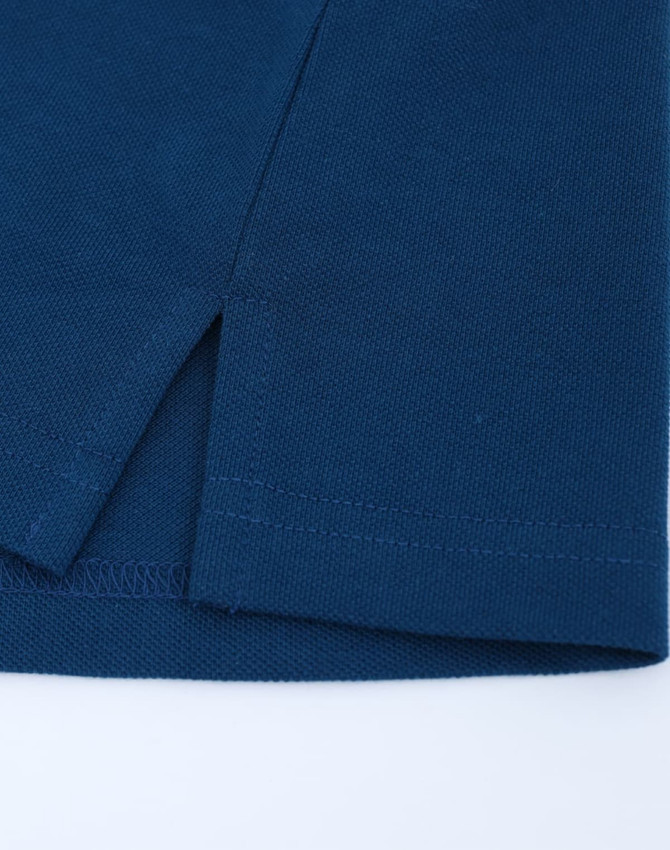 A navy blue men's polo featuring a pique texture and side vents at the hem. It has a logo.