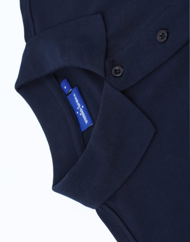 A navy blue men's classic cotton/poly pique short sleeve polo with a collar and buttons. Features a logo.