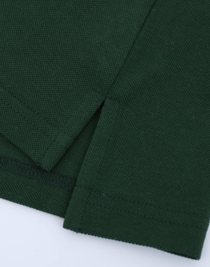 A green ladies' classic cotton/poly pique short sleeve polo, featuring detailed stitching and side slits.