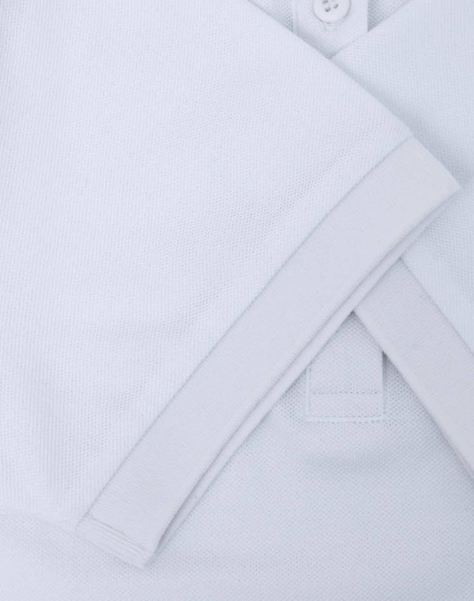 A white ladies' ultrafine cotton pique polo with rolled sleeves and a folded collar, featuring a logo.