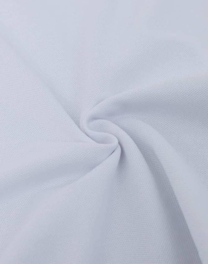 A close-up view of soft, ultrafine cotton pique fabric in white, showcasing its texture and weave.
