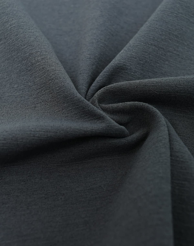 A close-up of dark grey fabric, showcasing a soft and smooth texture, with a slight stretch.