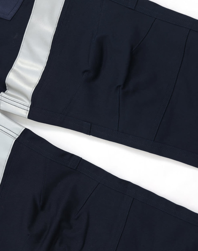 Cotton stretch drill cuffed work pants in navy with reflective tape detail, featuring a logo.