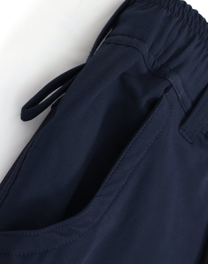 Navy blue DWR water repellent flexi work pants with elastic waistband and adjustable ties, featuring side pockets.